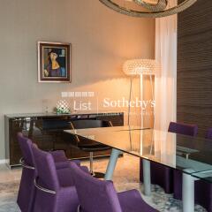 Modern dining room with purple chairs and glass table