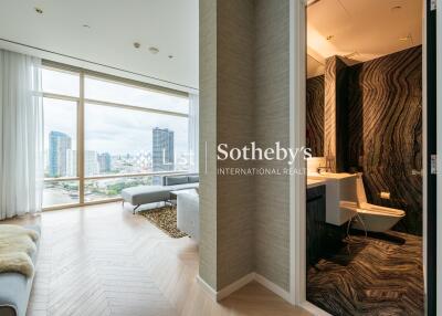 Modern living room with city view and adjacent luxurious bathroom