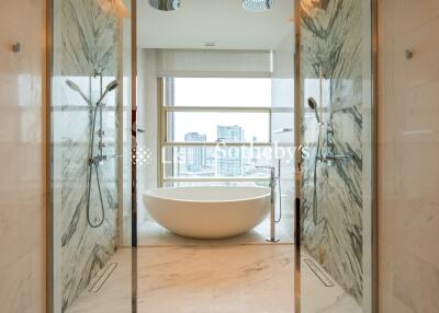 Modern bathroom with a freestanding bathtub and dual showers