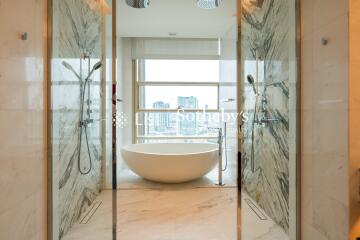 Modern bathroom with a freestanding bathtub and dual showers