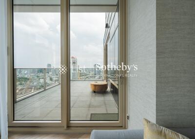 Living area with large glass doors leading to a spacious balcony