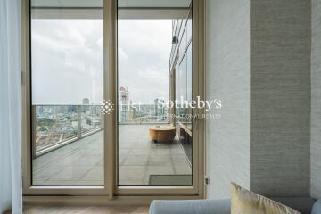 Living area with large glass doors leading to a spacious balcony