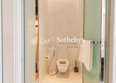 Modern bathroom with a toilet and glass shower door