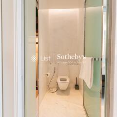 Modern bathroom with a toilet and glass shower door