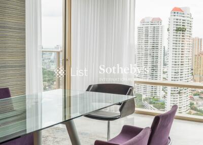 Modern dining area with glass table and city view