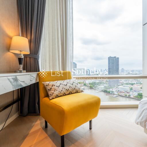 Living room with a yellow armchair and a city view