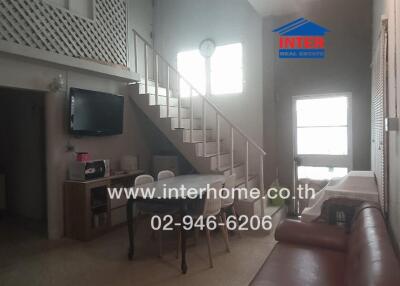 Modern living area with staircase and dining table