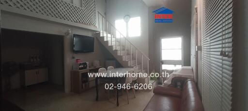 Modern living area with staircase and dining table