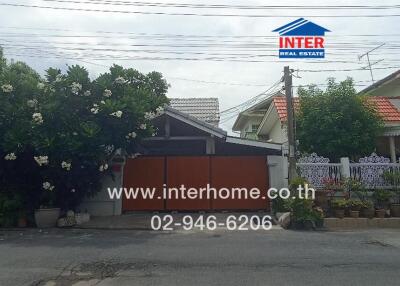 Street view of a house with a well-maintained garden