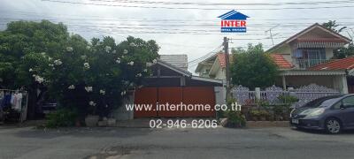 Street view of a house with a well-maintained garden