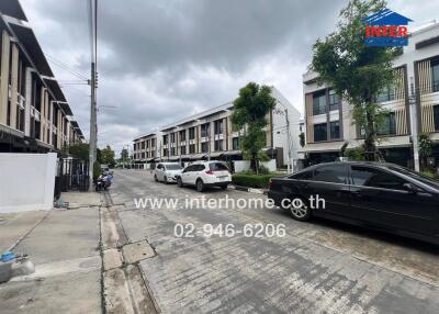 Residential area with parked cars and townhouses