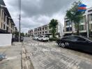 Residential area with parked cars and townhouses