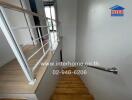 Staircase inside the building with wooden steps and white walls