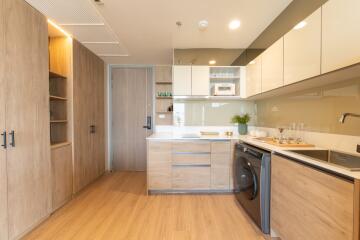 Modern kitchen with wooden cabinetry and built-in appliances