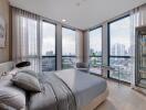 Modern bedroom with large windows and city view