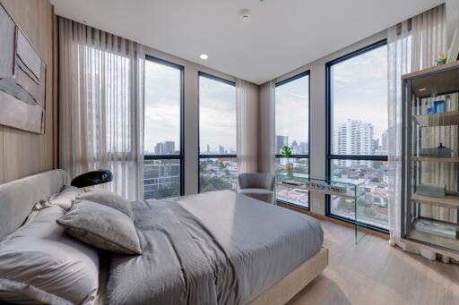 Modern bedroom with large windows and city view