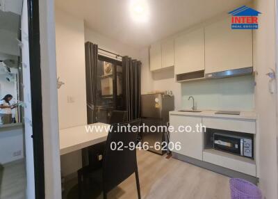 Compact modern kitchen with appliances and dining area