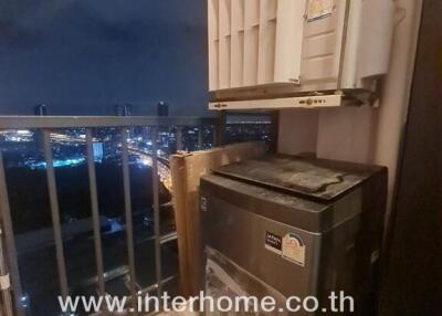 Outdoor laundry area with a washing machine and city view