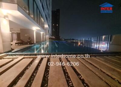 Outdoor pool at night in high-rise building