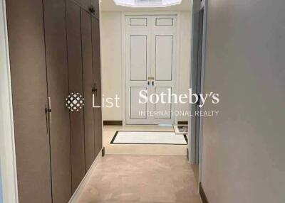 A hallway with built-in cupboards and a view of a doorway