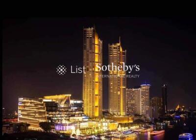 Night view of illuminated high-rise buildings near waterfront