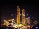 Night view of illuminated high-rise buildings near waterfront