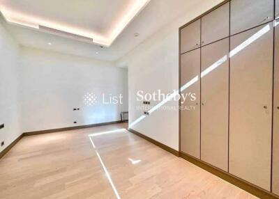 Bright bedroom with wooden flooring and built-in wardrobes