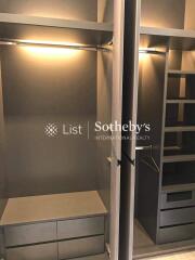 Spacious walk-in closet with ample storage and lighting