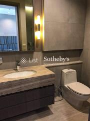 Modern bathroom with a large mirror and stylish lighting