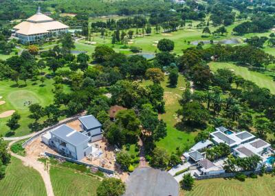 Aerial view of large property with surrounding greenery