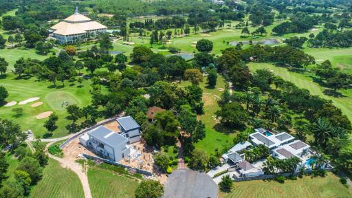 Aerial view of large property with surrounding greenery