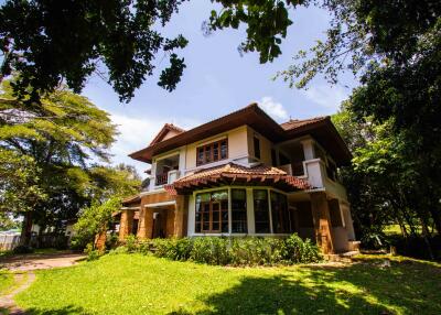 Front view of a two-story house with a large garden