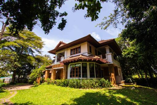 Front view of a two-story house with a large garden