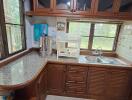 Wooden kitchen cabinets with windows and countertop