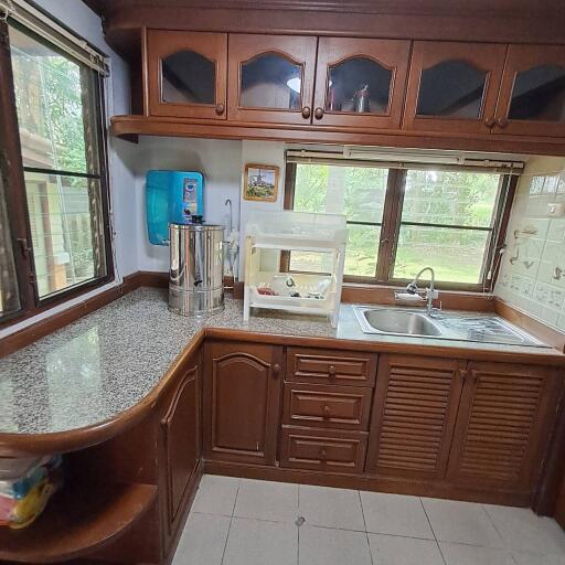 Wooden kitchen cabinets with windows and countertop