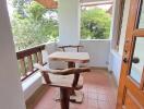 Rustic wooden furniture on a balcony with a view of greenery