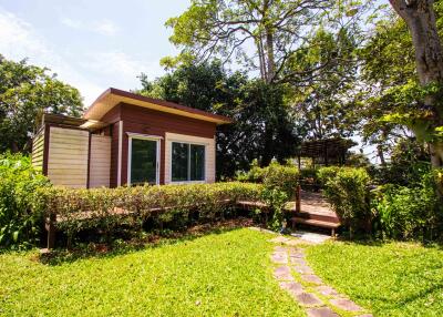 Exterior view of a small modern house with a garden