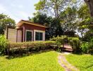 Exterior view of a small modern house with a garden