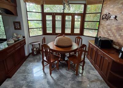 Dining room with wooden furniture and large windows