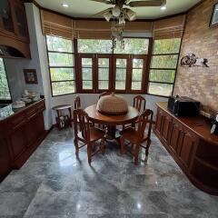 Dining room with wooden furniture and large windows