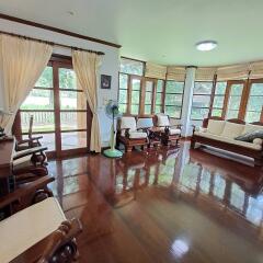 Spacious living room with wooden floors and large windows