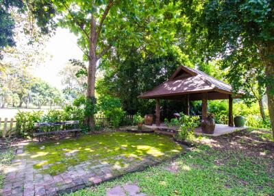 Beautiful garden area with a small pavilion and greenery