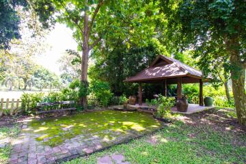 Beautiful garden area with a small pavilion and greenery