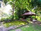 Beautiful garden area with a small pavilion and greenery