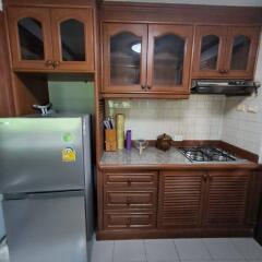 Modern kitchen with wooden cabinets and appliances