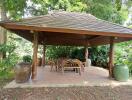 outdoor patio area with a roof and furniture