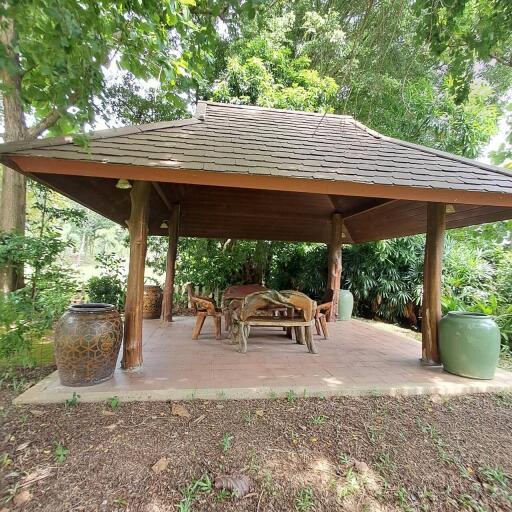 outdoor patio area with a roof and furniture