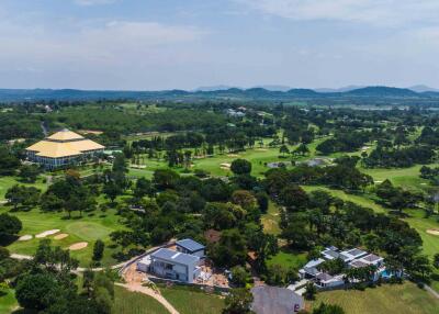 Aerial view of a property with surrounding greenery