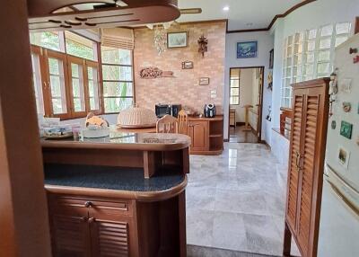 A cozy kitchen with wooden fixtures and a breakfast bar