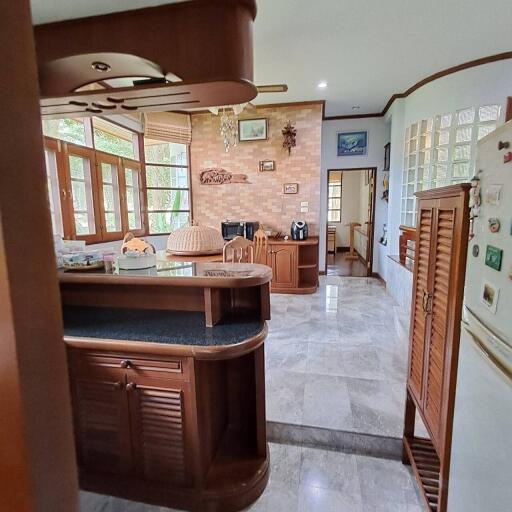 A cozy kitchen with wooden fixtures and a breakfast bar